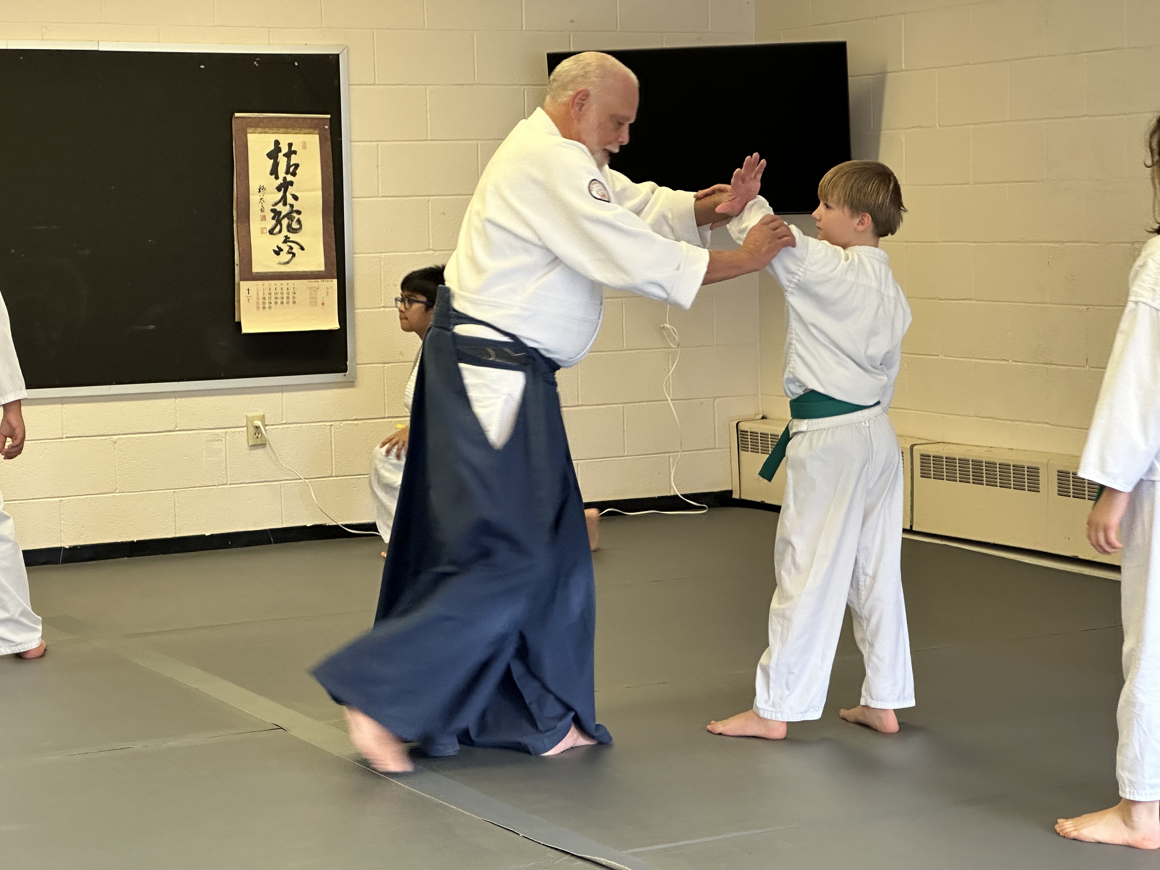Chief instructor practicing with a student in the kids' class